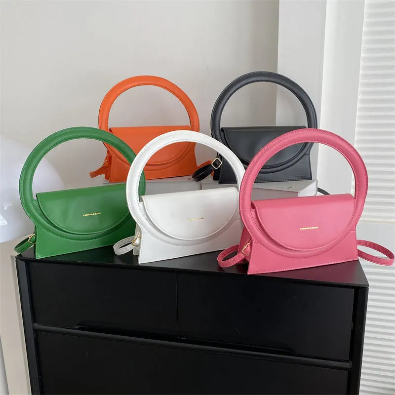 A square-shaped PU messenger bag in a choice of colours, showing external stitching and a sandwich pocket.