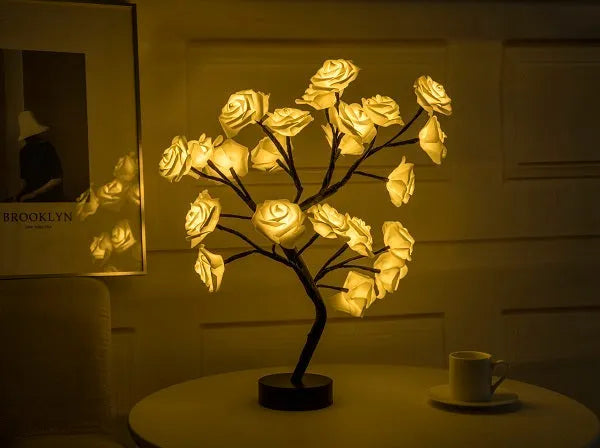 White and red rose flower LED lamp on a table with bonsai tree shape and warm white glow.
