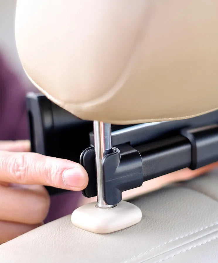 Black car phone holder mounted on vehicle rear seat with tablet secured in snap-in bracket