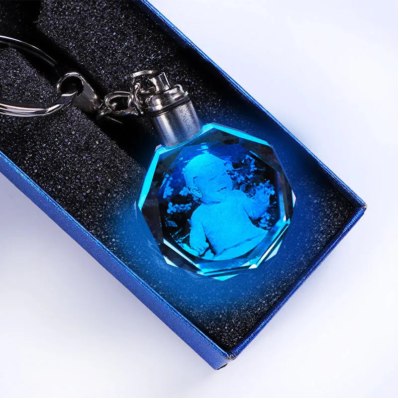 Custom laser-etched crystal photo keychain with internal colourful LED light activated, showing a personalised image.