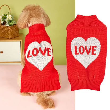 Dog wearing red love heart design sweater with bow decoration