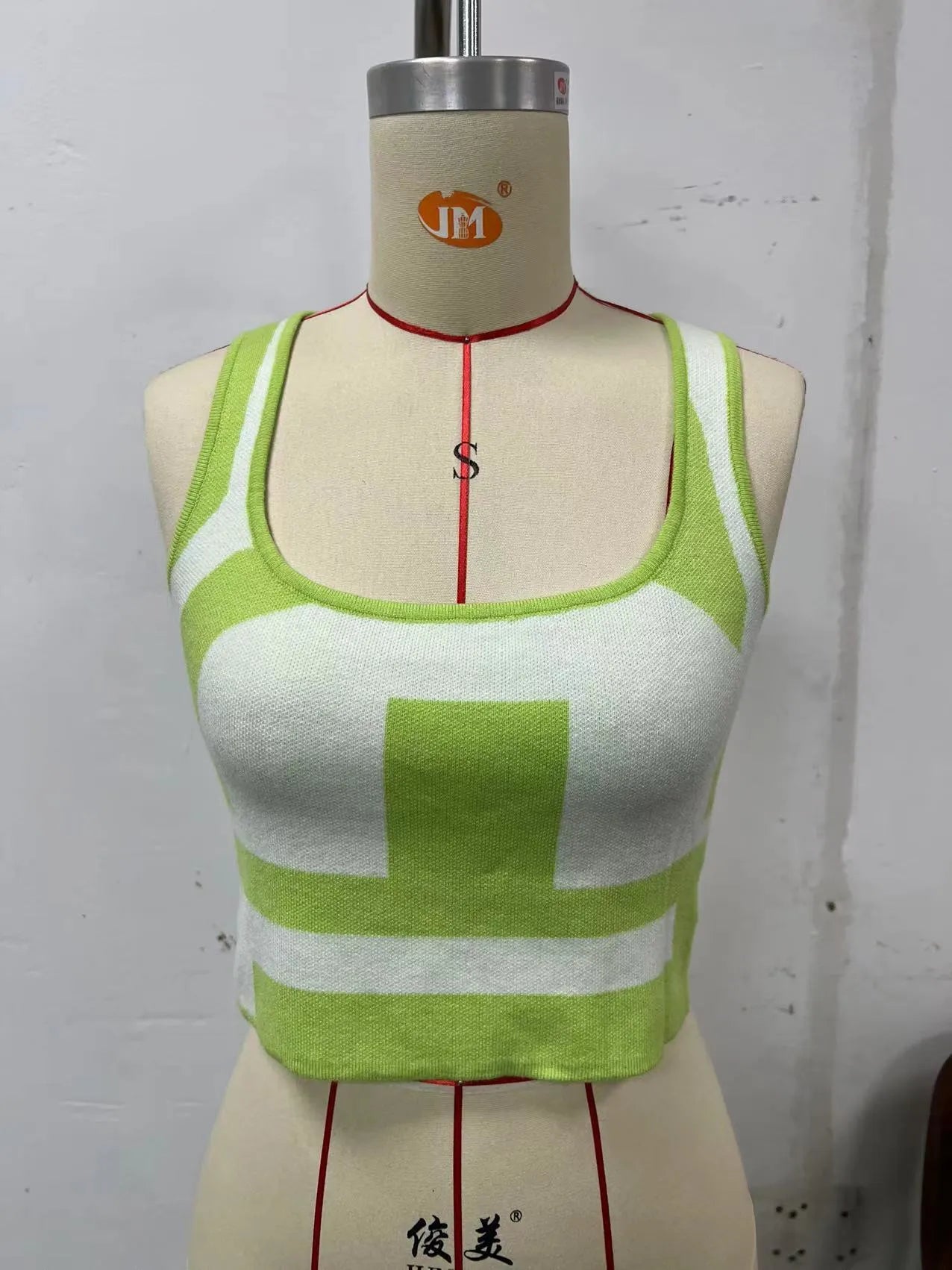 Women's white U-neck slim fit camisole vest with a crop hem, on a mannequin.