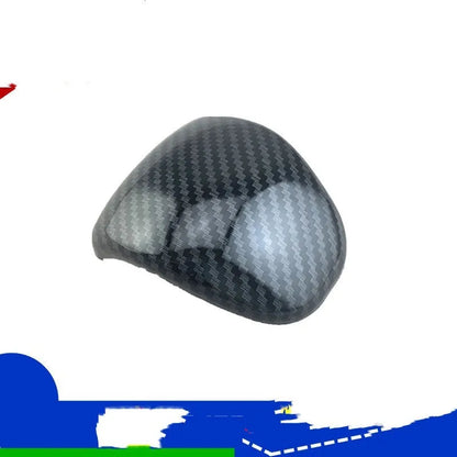 Black carbon fibre effect plastic cover for a car gear shift knob.