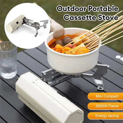 Green folding camping gas stove with serrated pot bracket, showing 25cm size next to butane canister