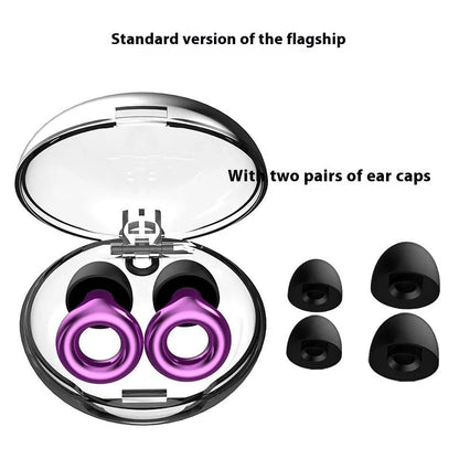 Set of gold-coloured noise reduction earplugs with a storage box and spare ear caps on a white background.
