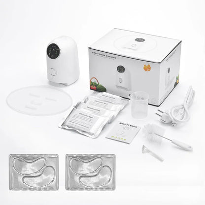 White plastic homemade face mask maker with tray, scraper, measuring cup, 32 effervescent tablets, and power cord.