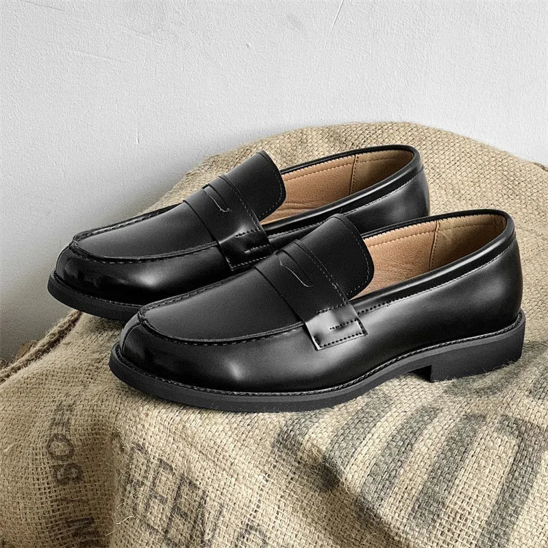 Classic black slip-on Derby leather shoes for men and women on a plain background