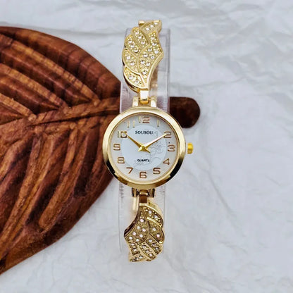 Stainless steel women's watch with round dial and vachette clasp on wrist.