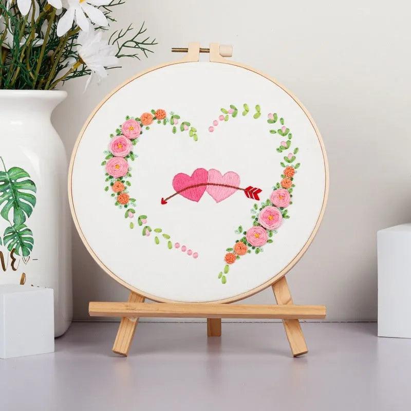 DIY Valentine's heart embroidery kit with cotton cloth and 20cm bamboo ring on a table.