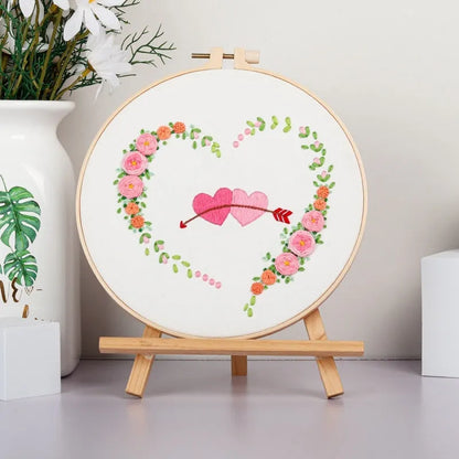 DIY Valentine's heart embroidery kit with cotton cloth and 20cm bamboo ring on a table.