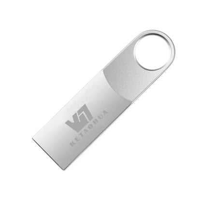 Custom silver metal car-shaped USB flash drive on a white background