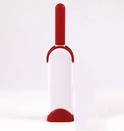 Blue reusable pet hair removal brush with double-sided head next to its self-cleaning base.