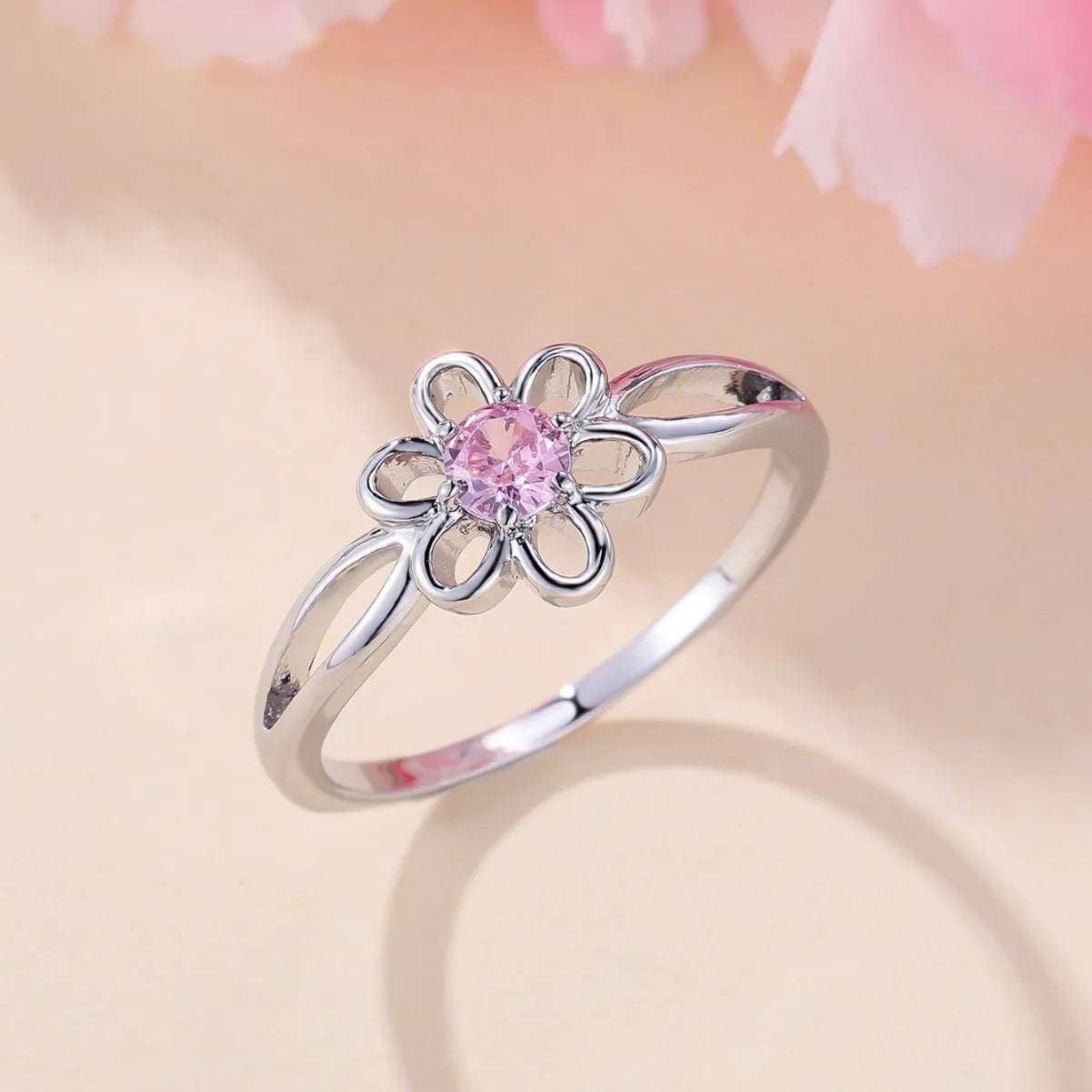 Women's flower hollow ring in pink diamond colour with floral design on copper band