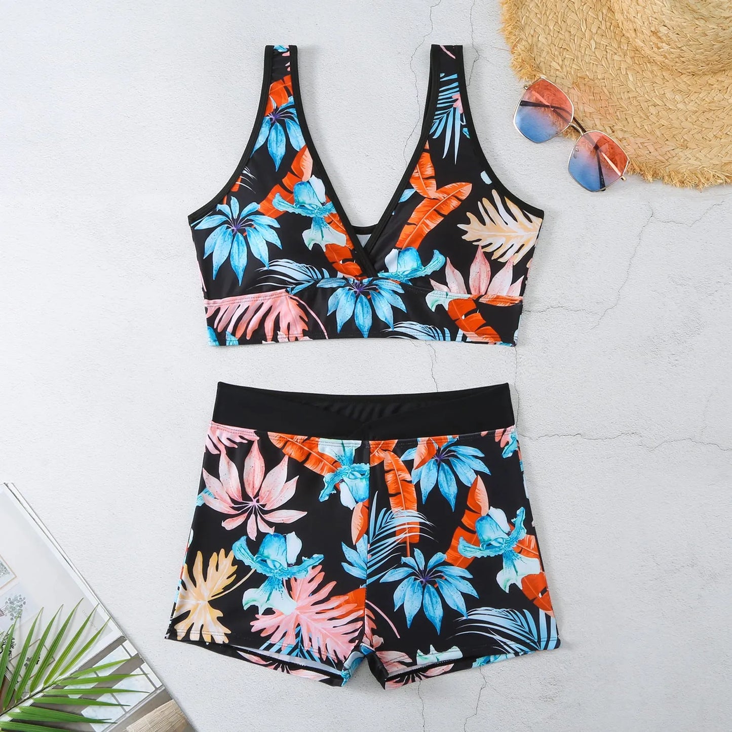 Women's two-piece swimsuit set showing sleeveless bikini top and printed boxer-style briefs in a multi-colour pattern.