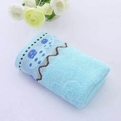 Cotton face towel in blue, pink and yellow colours with heart patterns, dimensions 73x33cm