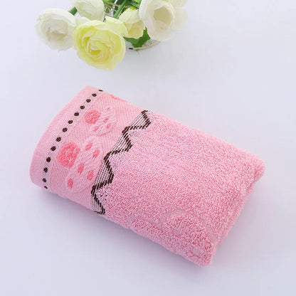 Cotton face towel in blue, pink and yellow colours with heart patterns, dimensions 73x33cm