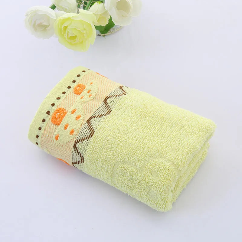 Cotton face towel in blue, pink and yellow colours with heart patterns, dimensions 73x33cm