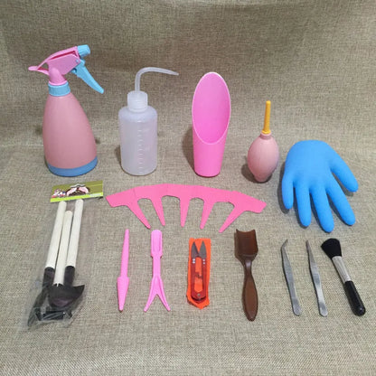 Succulent gardening tool set showing mini shovel, watering can, tweezers, and rake on a table.