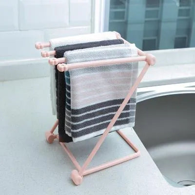 Foldable plastic dishcloth shelf organiser in light blue mounted on a wall.