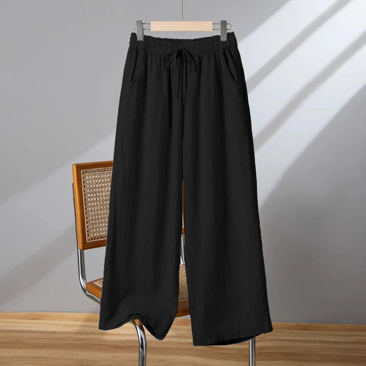 Women's apricot straight-leg casual trousers with elastic waist and drawstring lace-up detail.