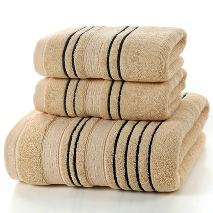 Household pure cotton towel set showing one large bath towel and two smaller hand towels in a neutral colour like grey or khaki.