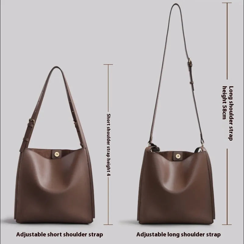 Brown genuine leather women's bucket-style commuter bag with double shoulder straps showing internal compartments