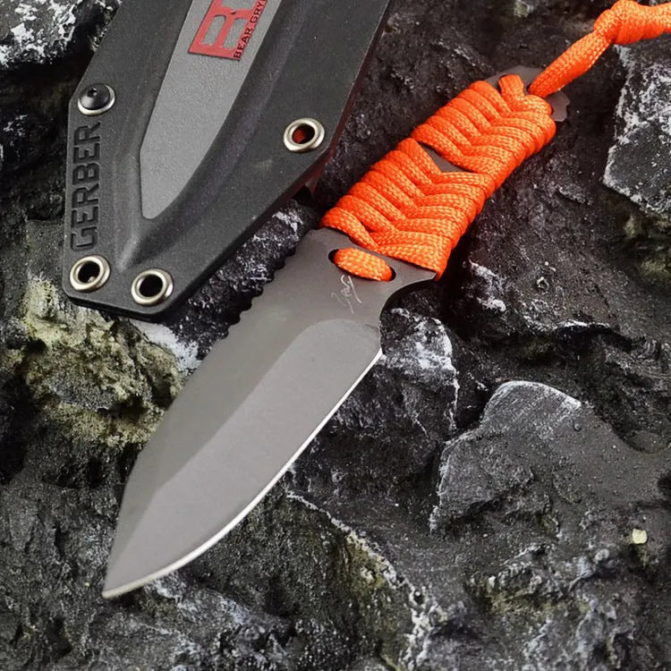 Straight-blade survival knife with a binding rope handle next to its black ABS plastic sheath.