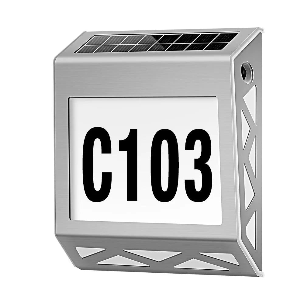 Black solar doorplate light with LED illumination showing house numbers