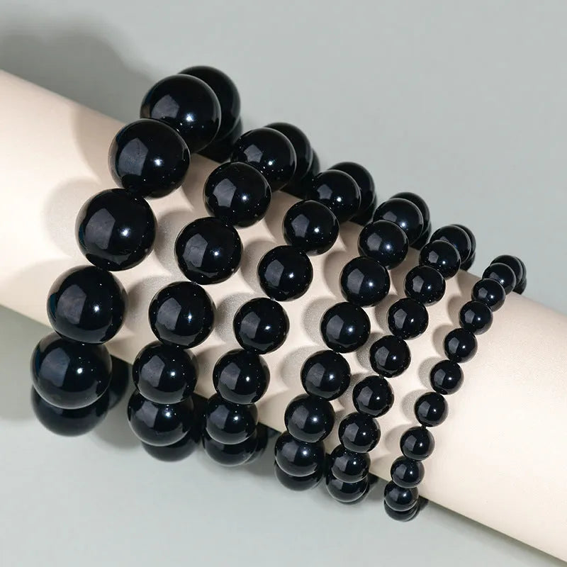 Hand-woven obsidian crystal bracelet showing round beads with ethnic styling in multiple colour options