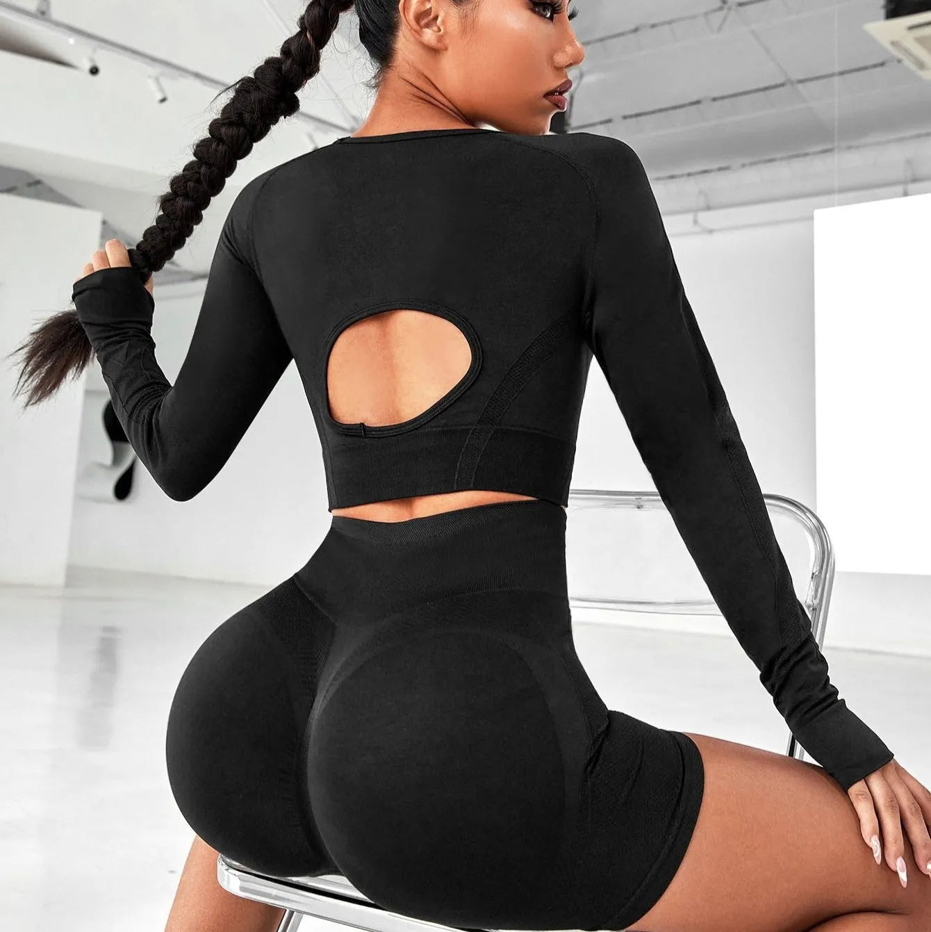Women's high waist yoga suit in black colour showing long sleeve top and matching leggings