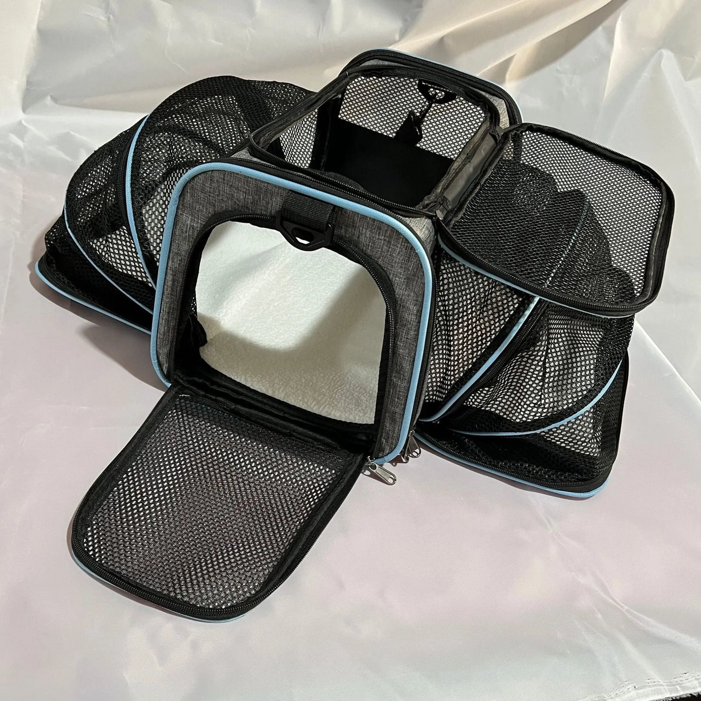 Black and grey portable cat carrier bag with 600D cation fabric construction.