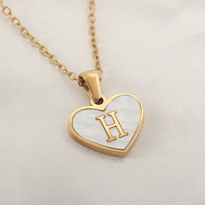 Gold-plated heart necklace with white shell pendant showing letter personalisation option
