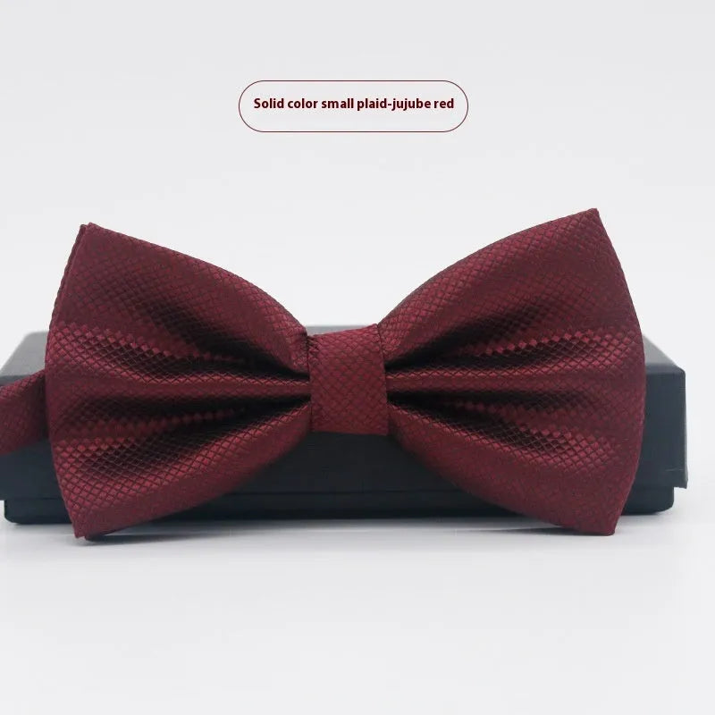 A solid colour pre-tied bow tie with an adjustable neck strap, shown in a classic flat head shape.