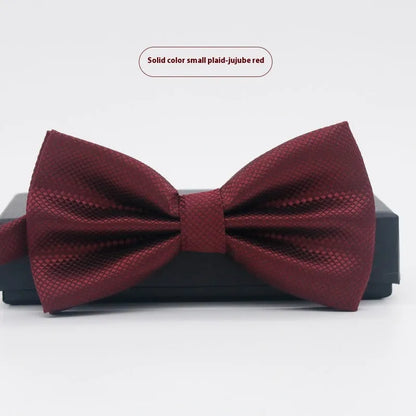 A solid colour pre-tied bow tie with an adjustable neck strap, shown in a classic flat head shape.