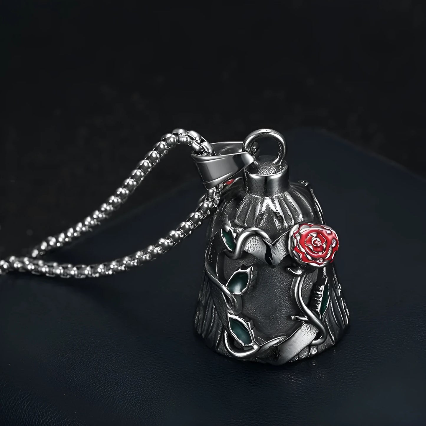 Polished titanium steel motorcycle bell with clear epoxy rose detail, shown from the side.