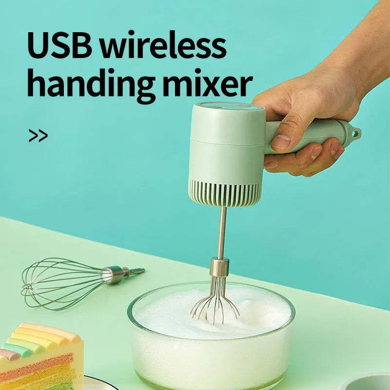 Green rechargeable electric hand mixer with whisk and beater attachments on a kitchen counter