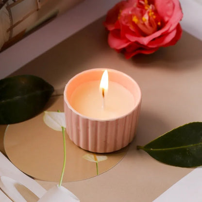 Soy wax aromatherapy candle inside a handmade ceramic cup, shown in a mint green colour.