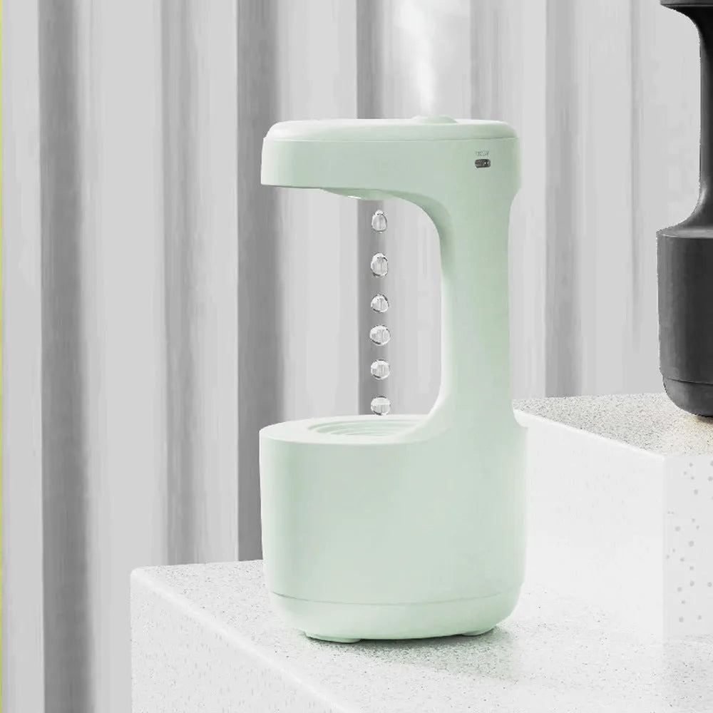 White columnar anti-gravity humidifier with water droplet backflow and LED clock display on a desk.