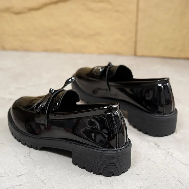 Women's brown artificial PU loafers with a bow detail on the pointed toe, shown on a size label.