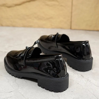 Women's brown artificial PU loafers with a bow detail on the pointed toe, shown on a size label.