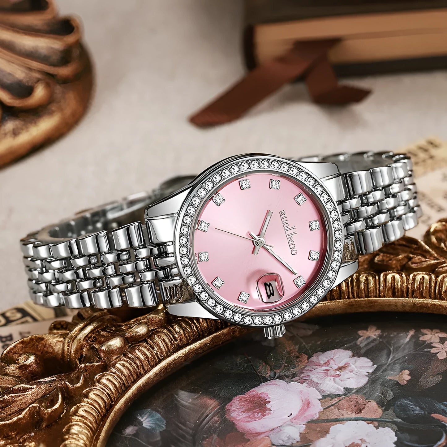 Women's silver alloy quartz watch with circular dial and stainless steel folding buckle.