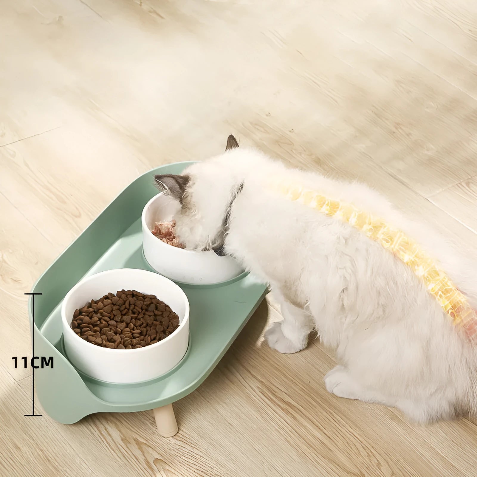 Green tilted pet feeder with adjustable stainless steel frame and two food bowls for cats and dogs