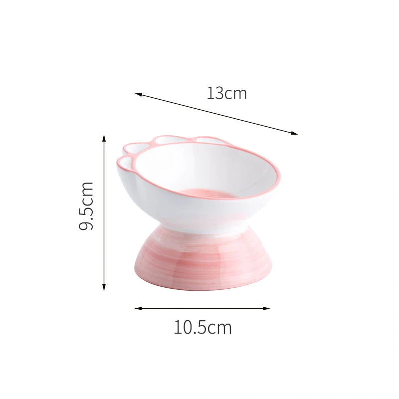 Ceramic pet bowl with cartoon paw design and 15-degree incline for comfortable feeding