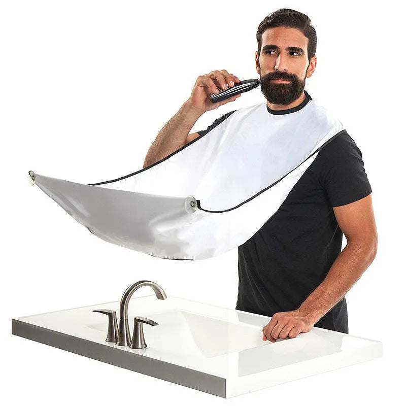 Professional transparent barber shaving cape with built-in tool tray and suction cup, shown in black.