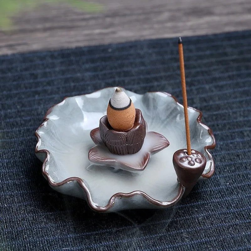 Square ceramic incense burner with reverse flow design showing smoke cascading down sides, Ge kiln crackle glaze patterns visible
