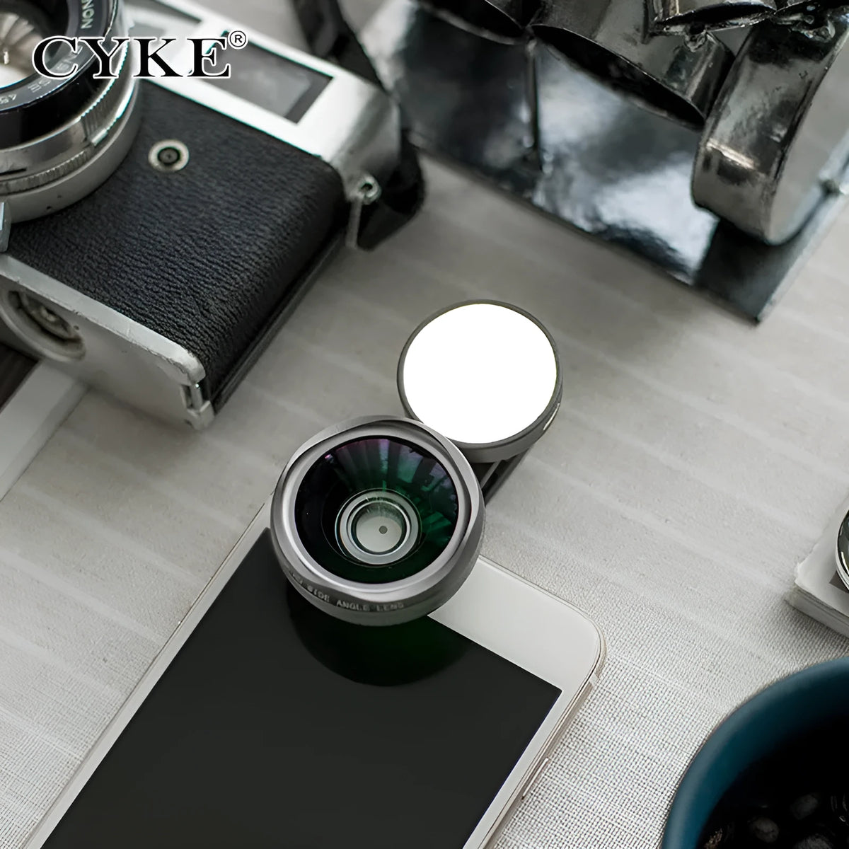 External wide-angle lens and colourful LED light ring attached to a smartphone via a universal mounting clip.
