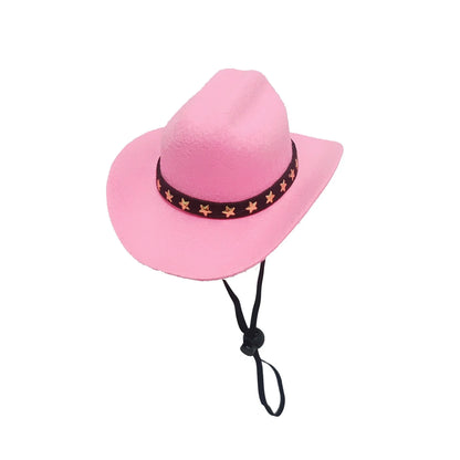 A small black cowboy hat with white stars on a non-slip surface, showing its adjustable strap.