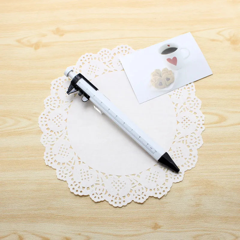 Orange multifunction ballpoint pen with integrated silver slide caliper, showing 15cm length and 0.5mm tip.