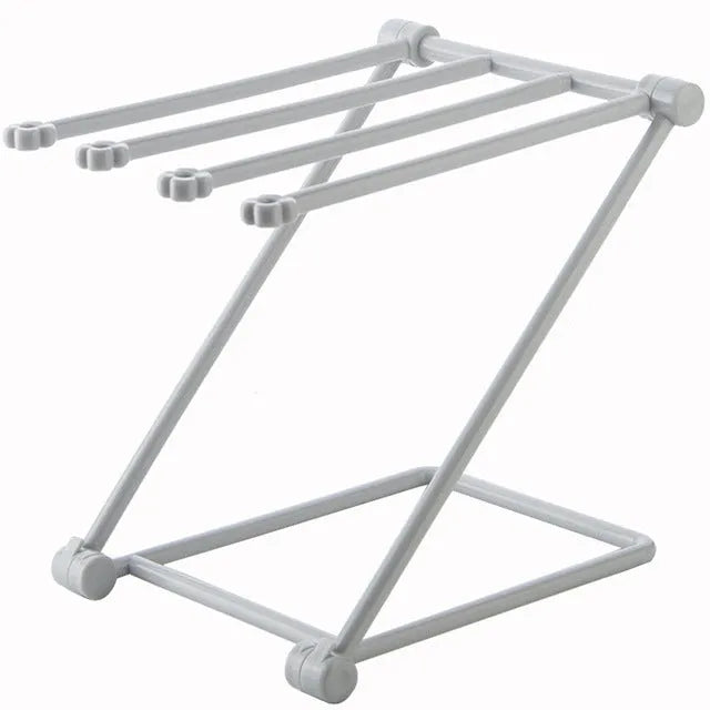 Foldable plastic dishcloth shelf organiser in light blue mounted on a wall.