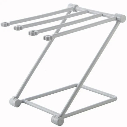Foldable plastic dishcloth shelf organiser in light blue mounted on a wall.
